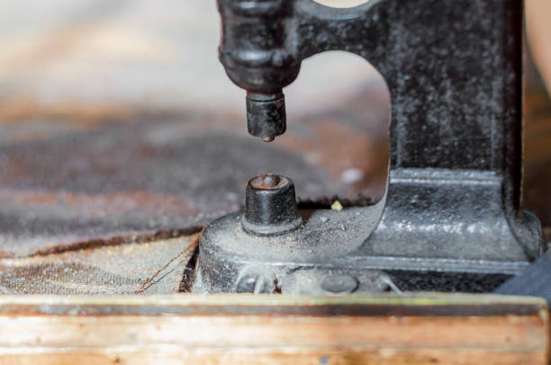 Vintage hand-press for setting rivets on clothes. The shoemaker's workshop.Vintage hand-press for setting rivets on clothes. The shoemaker's workshop.