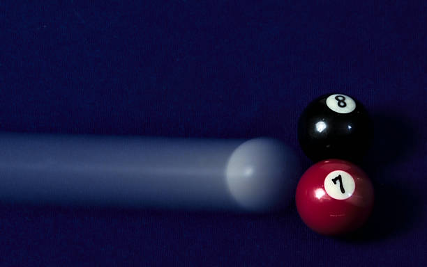 istock White pool ball hitting black and red ones 956977736