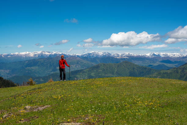istock Adventurer is relaxing on a green mountain meadow 956982002