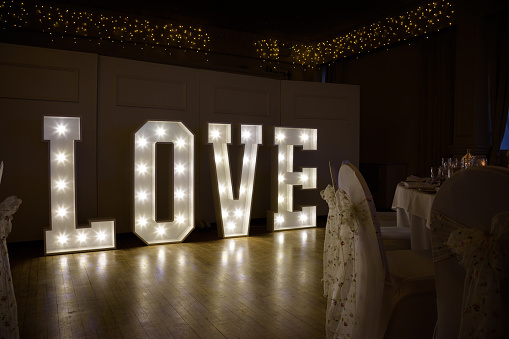 Illuminated Love sign in large letters at a wedding reception