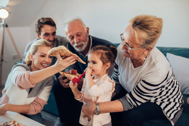 istock Happy family enjoying pizza 956985474
