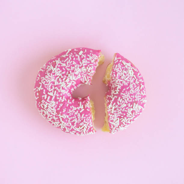 istock Flat lay of donut broken on two pieces abstract concept 956986180