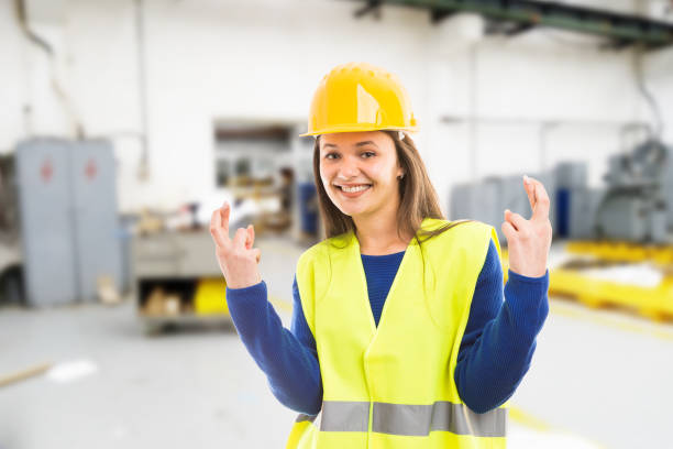istock Young female engineer making good luck gesture 956988686