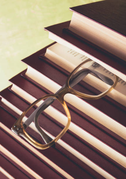 istock Old glasses on a pile of books 956990144