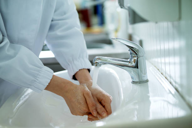 istock Worker washing his hands carefully before heading to work in a sterile environment. 956990796