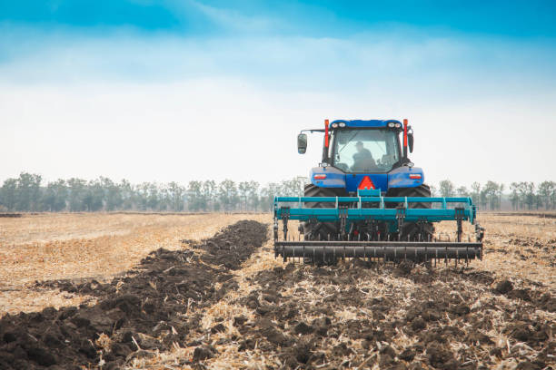 istock Modern tractor in the field on a sunny day. 956991010