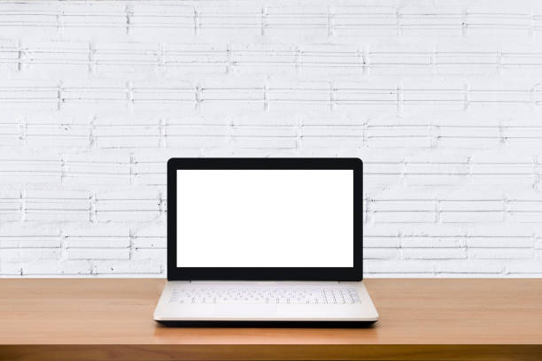 istock Mock up Laptop with blank screen on wooden table with modern interior background.Mock up business concept. 956993634