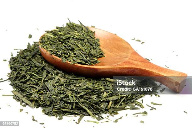 Partiallyfilled Wooden Spoon Laying On Loose Green Tea Stock Photo - Download Image Now