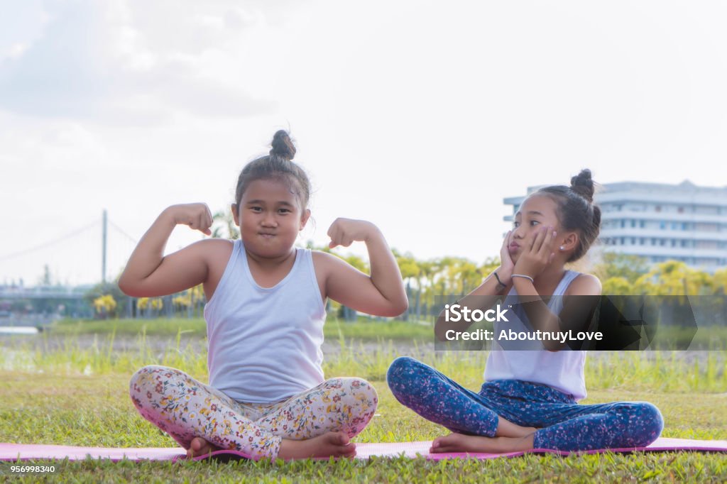the fat girl and thin girl playing have fun in the park , child girl baby have fun fat and thin Active Lifestyle Stock Photo