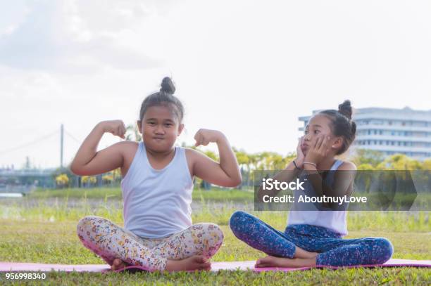 The Fat Girl And Thin Girl Playing Have Fun In The Park Child Girl Baby Have Fun Fat And Thin Stock Photo - Download Image Now