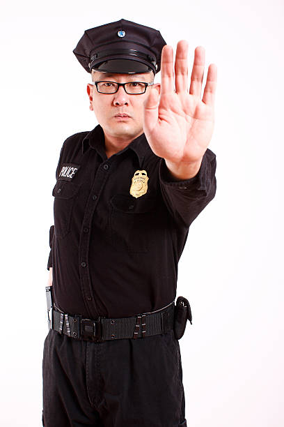 istock police officer gesturing to stop 95699837