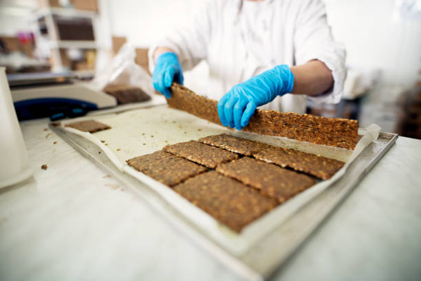 istock Freshly baked cookie mixture is being cut and getting ready to be packed. 957000770