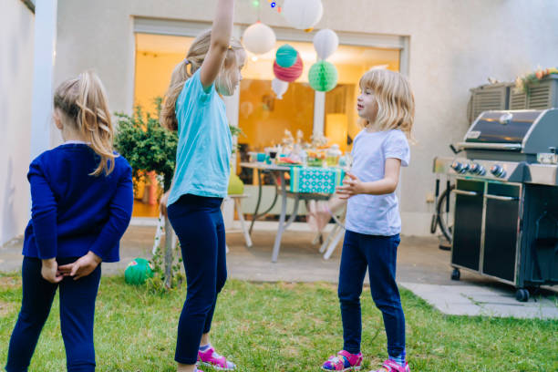 istock Cute Kids Having Fun Outside for Summer Backyard Party 957000932