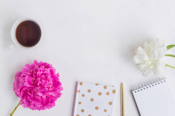 istock Flat lay desk with pink peony, gold notebook and accessories 957003112