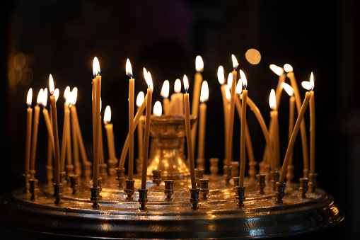 Church candles on the background bokeh. Dark background