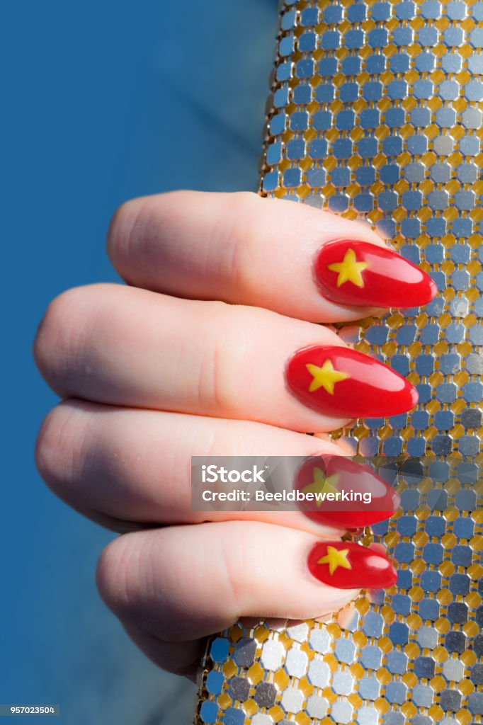 She  shows her chinees flag manicure with sequin clutch She  shows her red chinees flag manicure with gold sequin clutch Adult Stock Photo