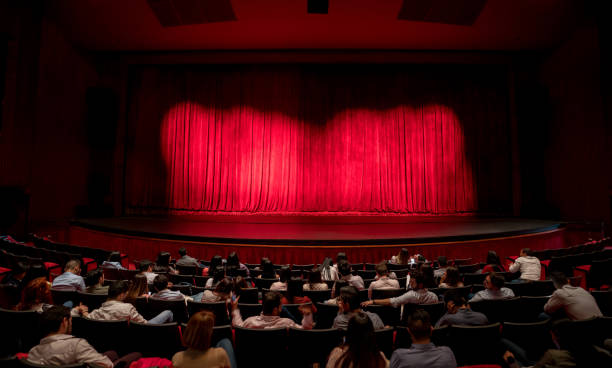 Anxious audience waiting for the curtains to open to see the performance Anxious audience waiting for the curtains to open to see the performance at the theater theatrical performance stock pictures, royalty-free photos & images