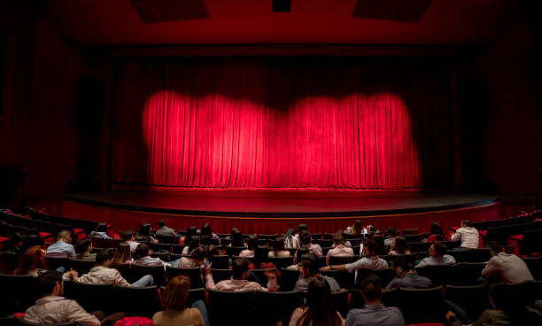 anxious audience waiting for the curtains to open to see the performance - palco imagens e fotografias de stock