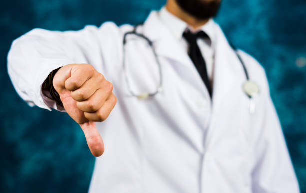 istock Doctor showing thumbs down close up 957030876