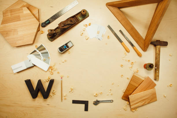istock Carpentry work tools on background with wooden cuttings. 957031102