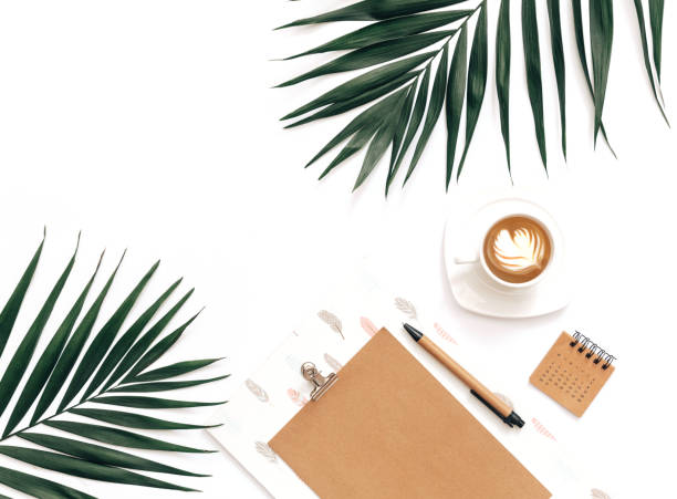 istock Flat Lay Home office workspace mockup with clipboard, tropical leaves  and coffee on white background. Blogger background 957031174