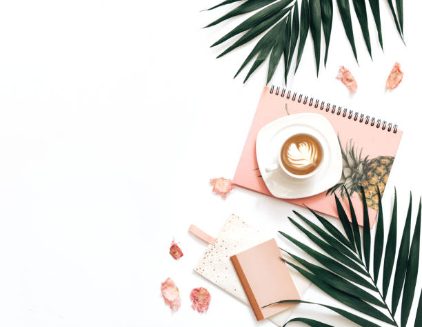 istock Flat lay blogger workspace mockup with tropical leaves , coffee and accessories on white background. Copy space 957031302