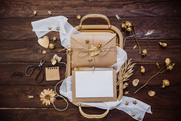 istock Empty greeting card with kraft envelope on wooden background. Top view, flat lay 957031364