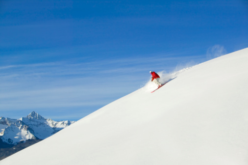 Male skiing fresh powder in the mountains. Top ski destinations in the world. Best ski resorts in North America.