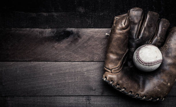 istock Vintage baseball gear on a wooden background 957042072