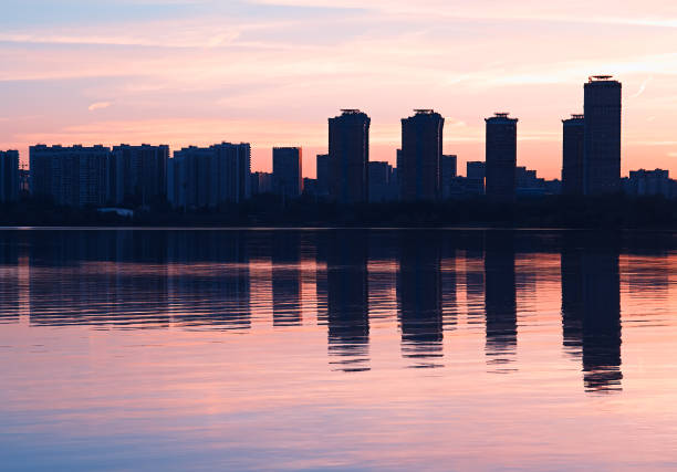 istock Modern skyscrapers with water reflections background 957042408