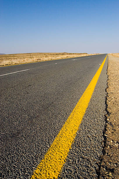istock Black Road with yeallow line and blue sky 95704301
