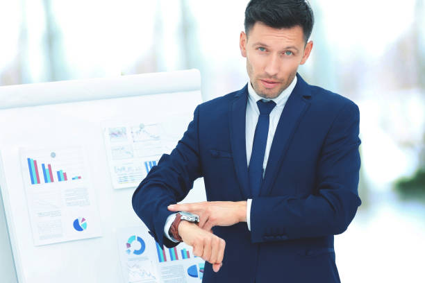 istock concept - save your time. businessman indicates a wrist watch on 957045814