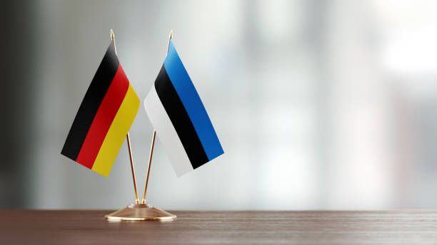 istock German And Estonian Flag Pair On A Desk Over Defocused Background 957050194