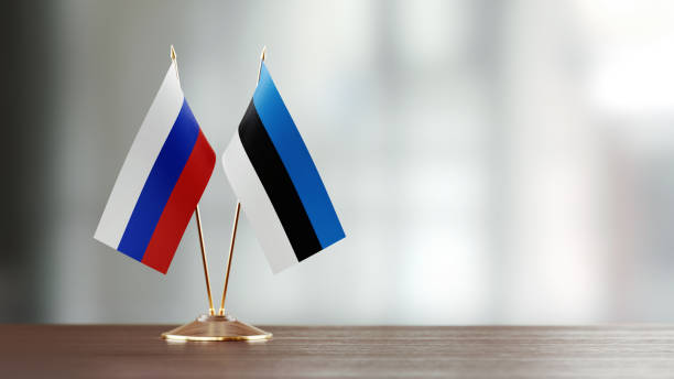 istock Russian And Estonian Flag Pair On A Desk Over Defocused Background 957050928