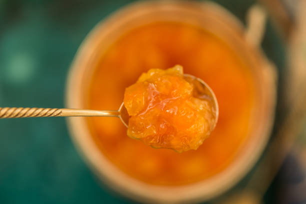 orange jam in a tea spoon - quince imagens e fotografias de stock