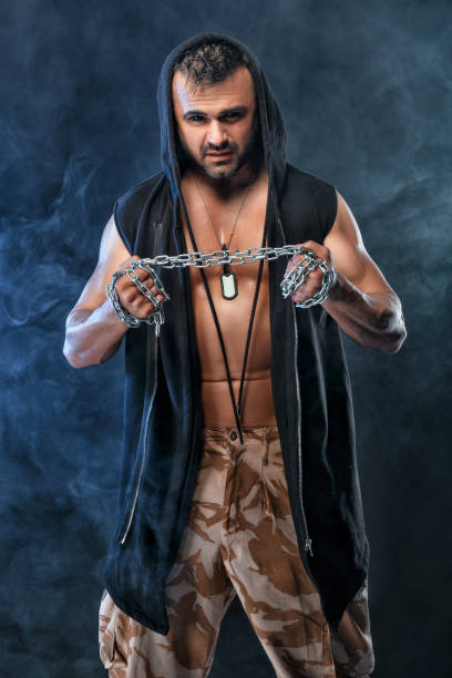 istock athletic handsome muscular man with chain 957057982