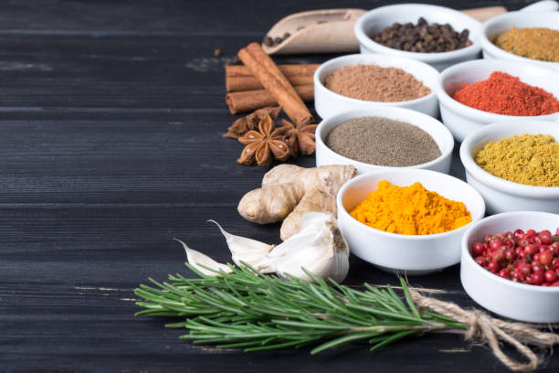 istock Colorful herbs and spices selection. Aromatic ingredients on wood table 957058110