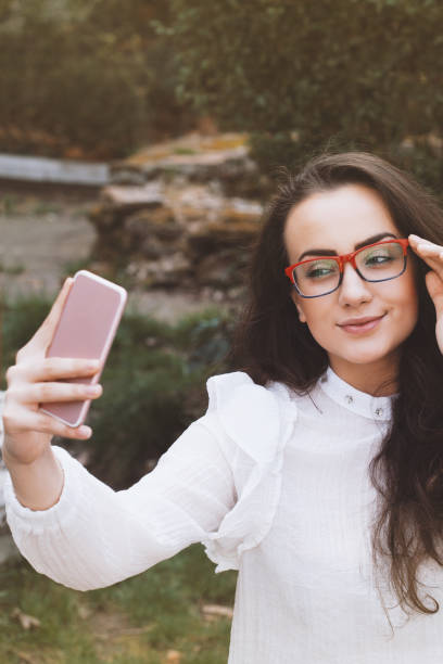 istock Beautiful young woman taking a selfie 957058214