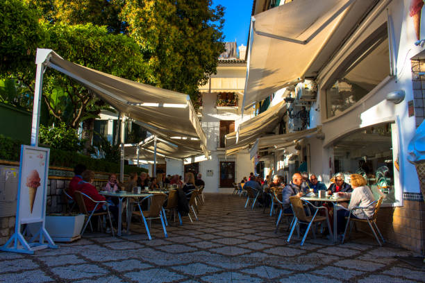 Square. A small square with restaurants and a fountain in Estepona. Malaga province, Andalusia, Spain. Picture taken – 4 may 2018.