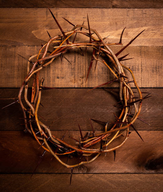 istock A crown of thorns on a wooden background. Easter Theme 957062154