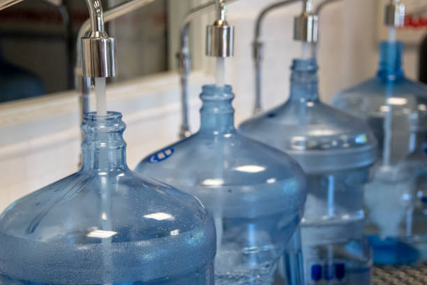 Purified water Big five gallon plastic containers being filled of purified water distillation photos stock pictures, royalty-free photos & images