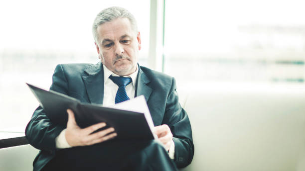 istock successful businessman studies working papers sitting on the sofa in the private office 957065218