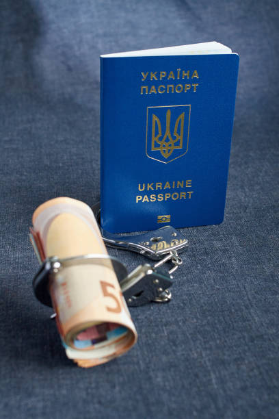 istock Ukrainian biometric passport and handcuffs on the table. 957068234