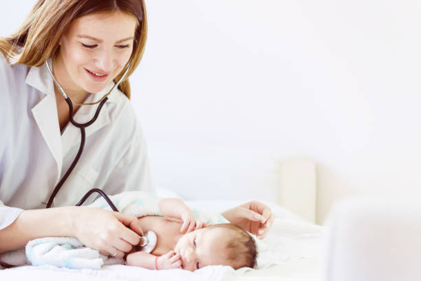 istock Female doctor examines infant with stethoscope 957068622