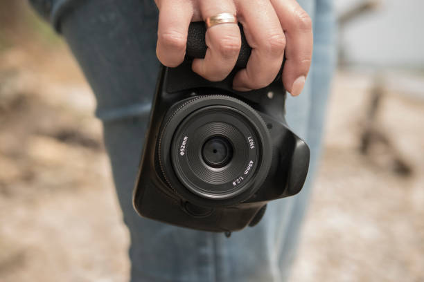 istock the photographer holds a camera in his hand 957079554