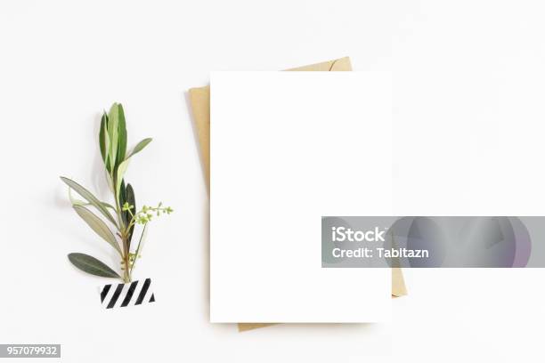 Feminine Stationery Desktop Mockup Scene Blank Greeting Card Craft Envelope Washi Tape And With Olive Branchwhite Table Background Flat Lay Top View Stock Photo - Download Image Now