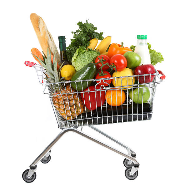 A shopping trolley overloaded with fresh food stock photo