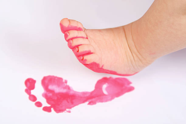 A newborn's tiny feet make up the V in LOVE for Valentine's Day.
