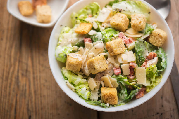 istock Chicken Caesar salad with bacon, parmesan and croutons 957081148