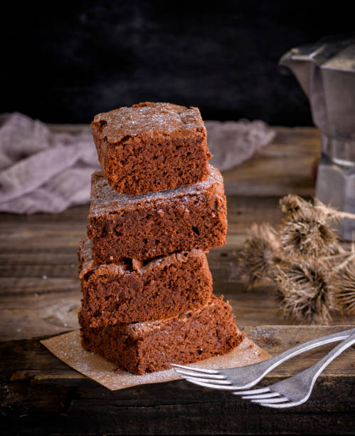 istock stack of square pieces of brownie and two iron forks 957083684